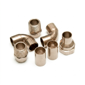 Set of copper nickel forged fittings on white background